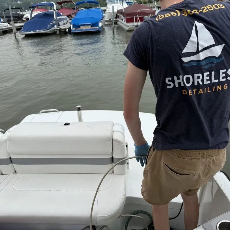 Shoreless Detailing technician working on a boat at a Finger Lakes marina